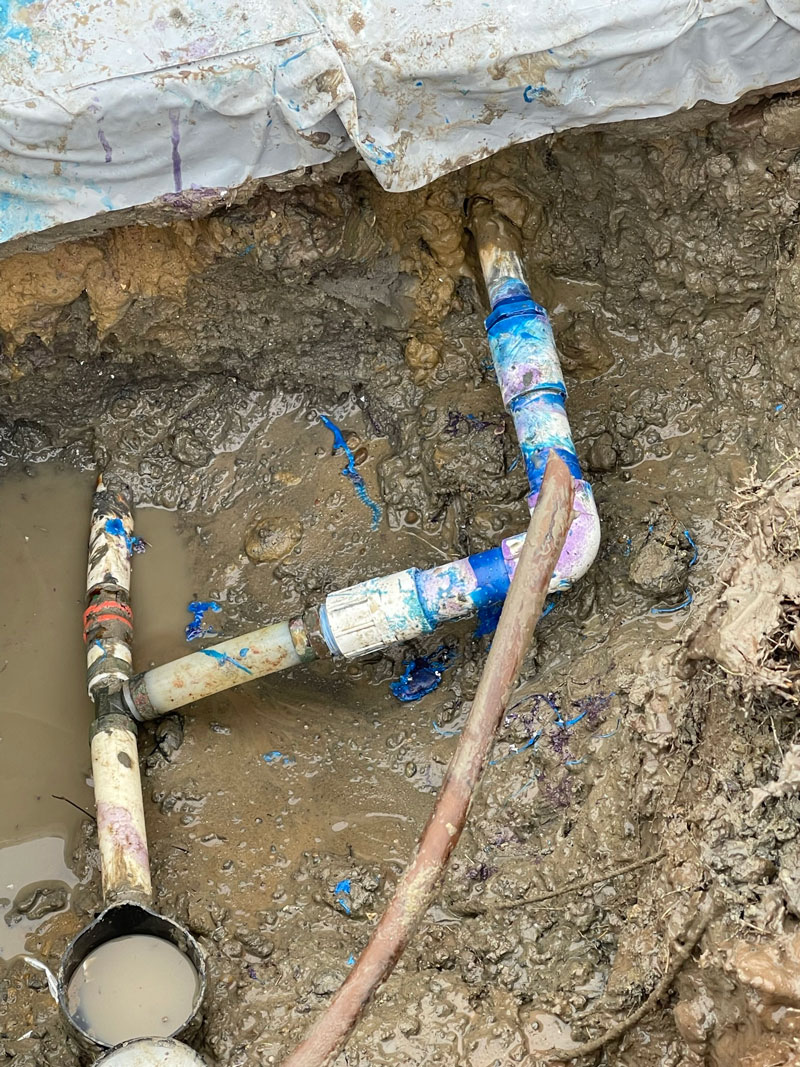 PVC water line repair in muddy trench after slab leak detection near Fort Worth home