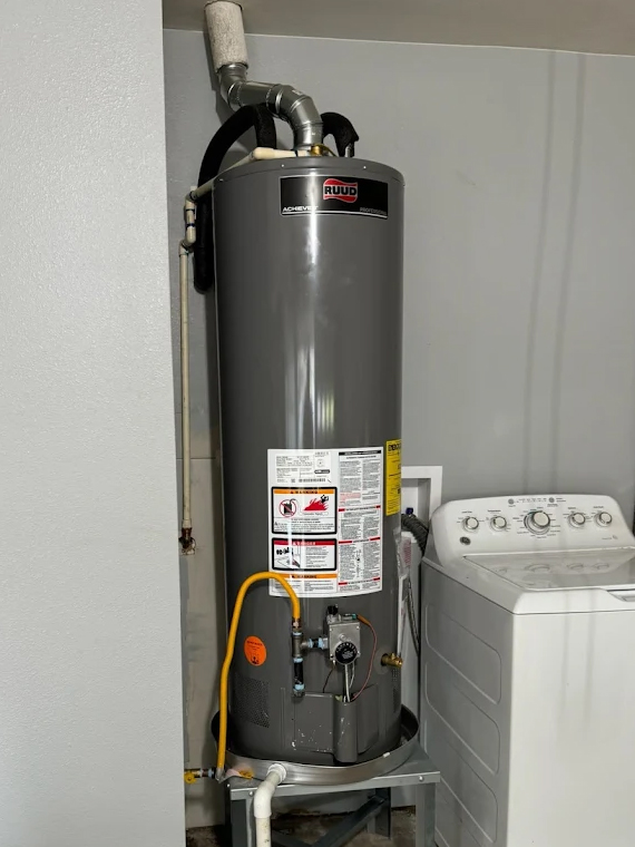 Newly installed RUUD water heater connected with flexible gas and water lines by Morgan Leak Detection & Plumbing in a DFW home.